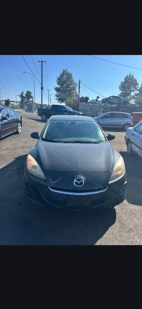 Dark sedan at a vehicle yard